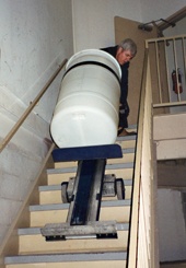 LW moving a drum down stairs